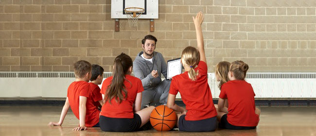 coach and players team talk on gym