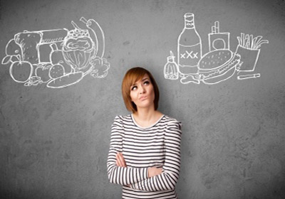 a woman choosing what healthy food to eat