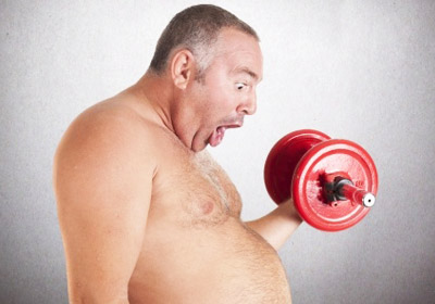 an obese aged man lifting dumbell