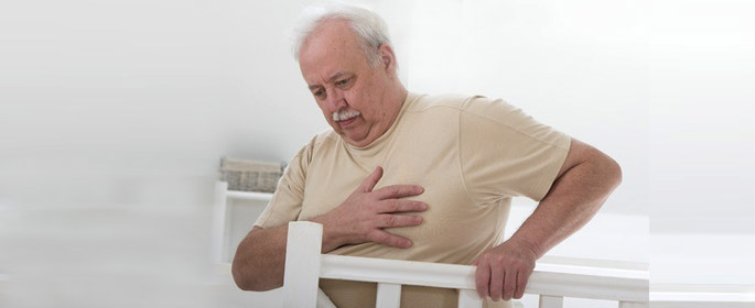 overweight senior man hand grabbing his chest