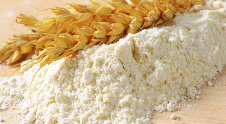 wheat ears on pile of soft flour